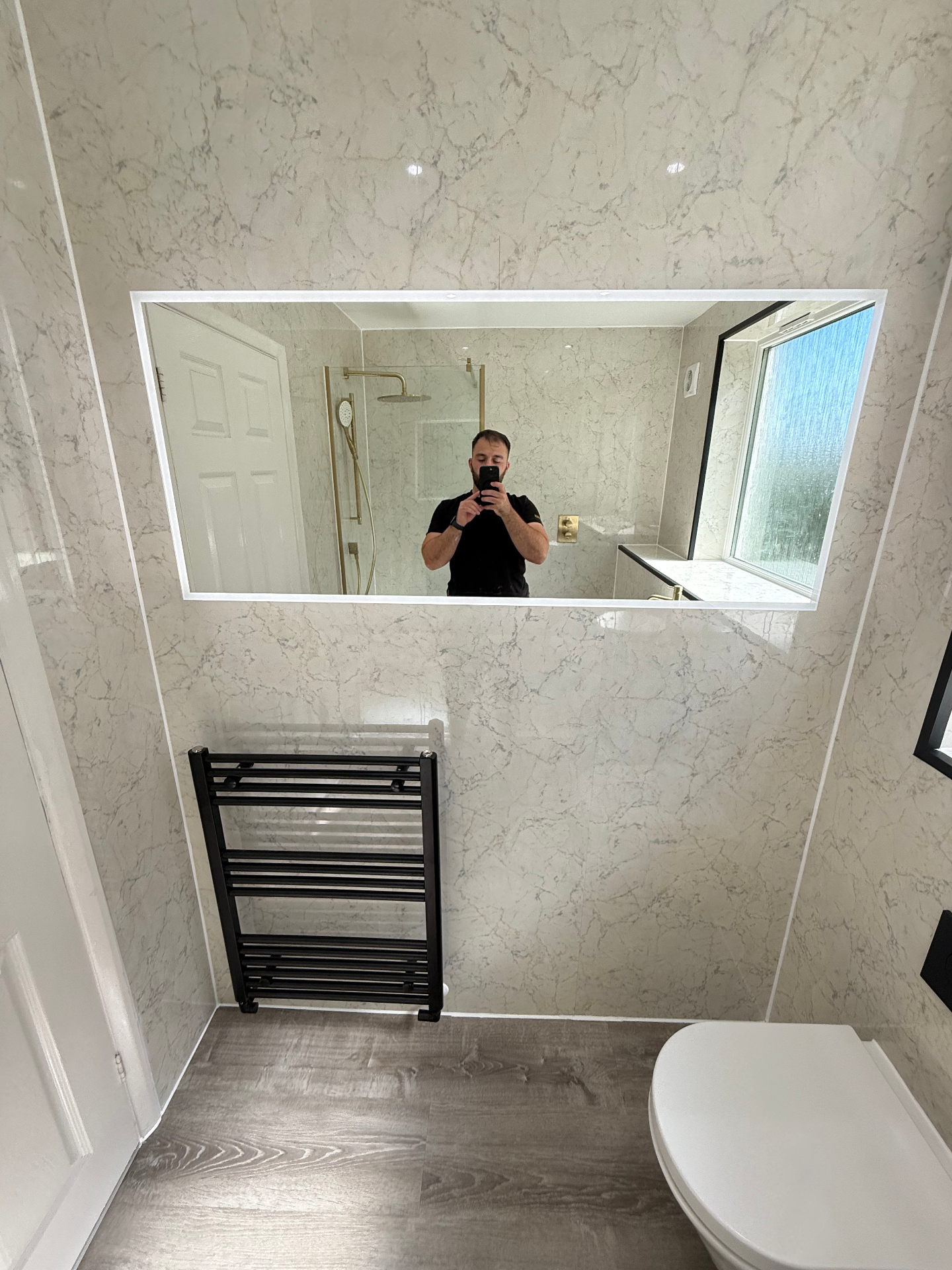 Modern bathroom with marble tiles and gold fixtures